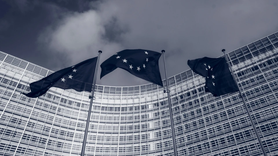 Photo by Christian Lue for Unsplash - EU Flags in front of the European Commission building in Brussels, Belgium