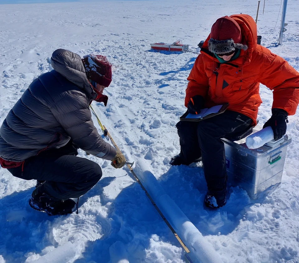 colleagues taking firn core samples from the Greenland ice sheet