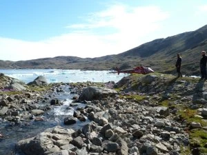 Geologist taking stream sediment sample during the MRAPSEG 2010 regional geochemical sampling