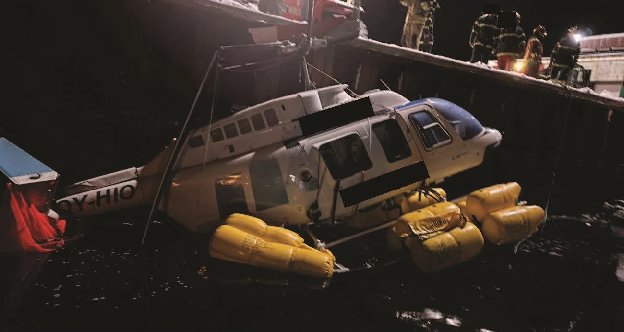 The helicopter lifted from the water onto the quay at Narsaq harbour